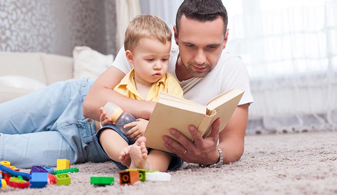 Parent with his kid reading book