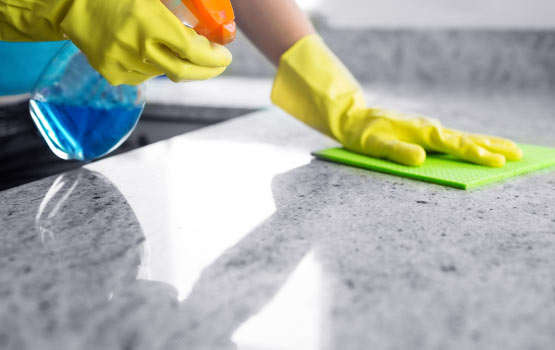 Professional cleaning of countertops using liquid spray cleansers.