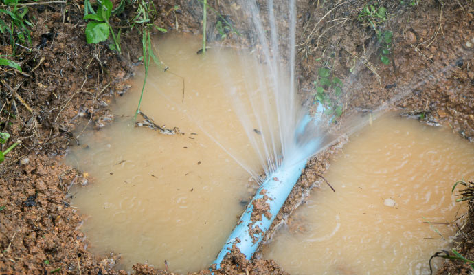 Water leaking out of a broken water pipe