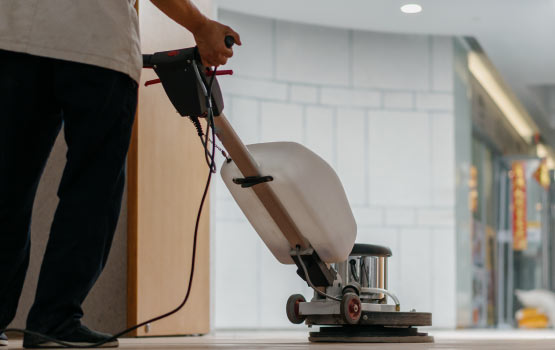 Professional cleaning limestone floor using equipment