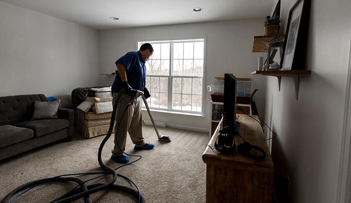 a carpeted room is undergoing a mechanized cleaning process.